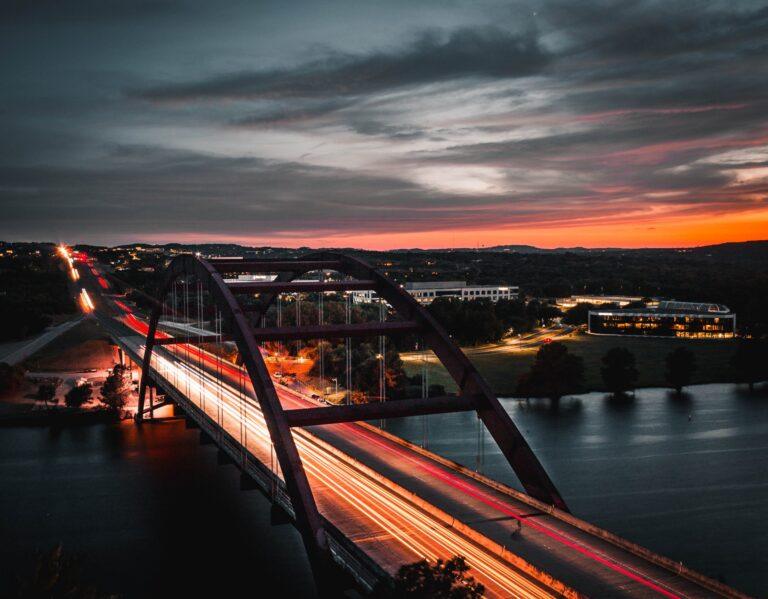 a long exposure photo of a bridge at night