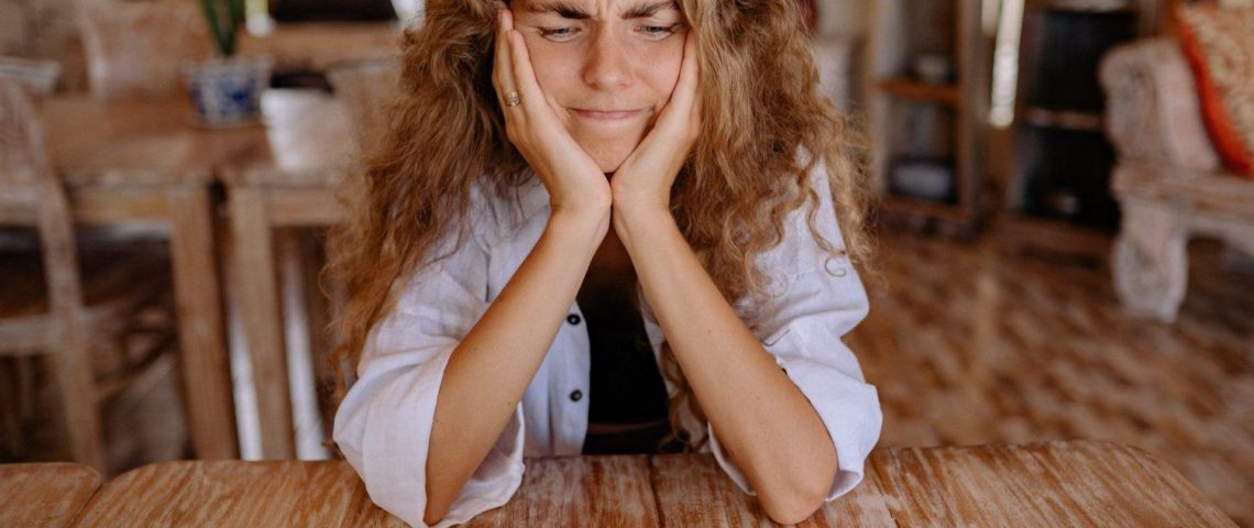 a woman sitting in front of a laptop computer