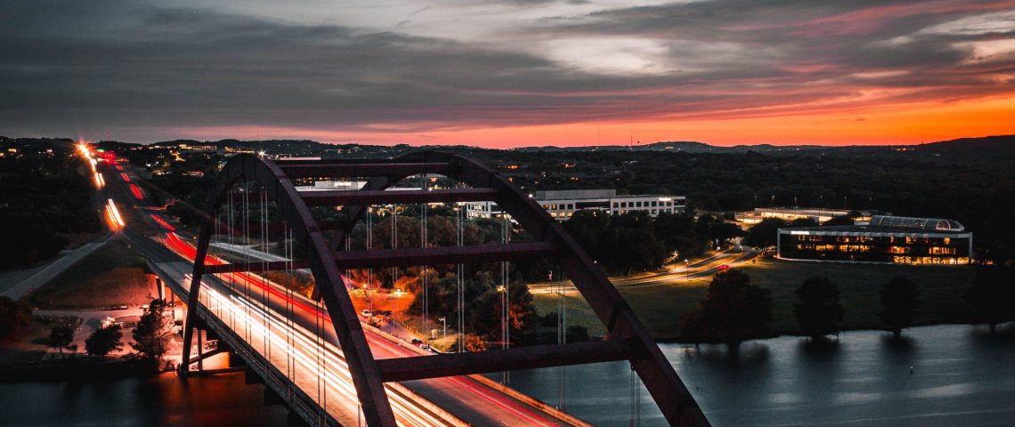 a long exposure photo of a bridge at night