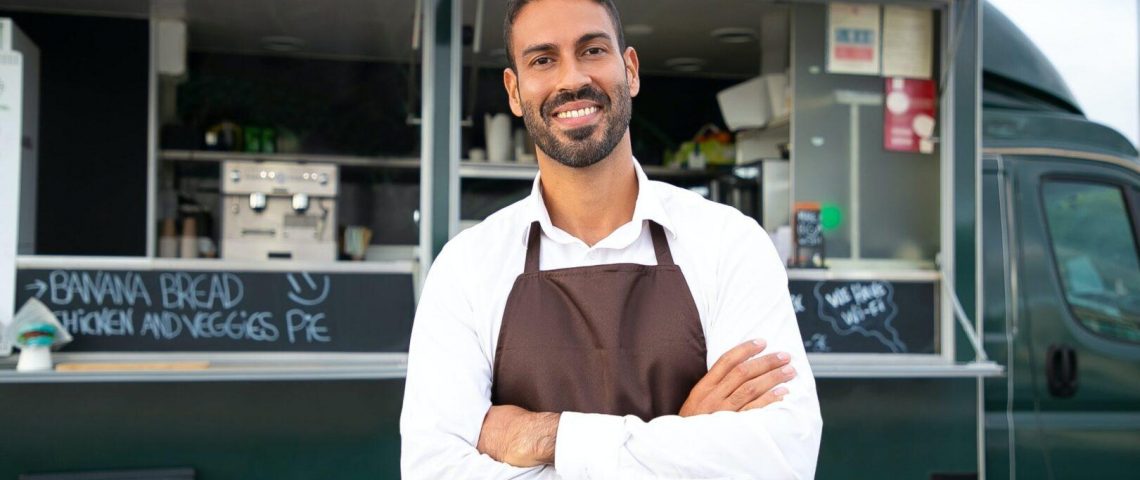 a man standing in front of a food truck