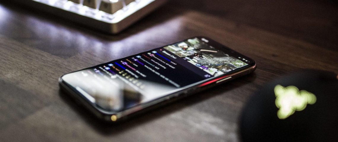 a cell phone sitting on top of a wooden table