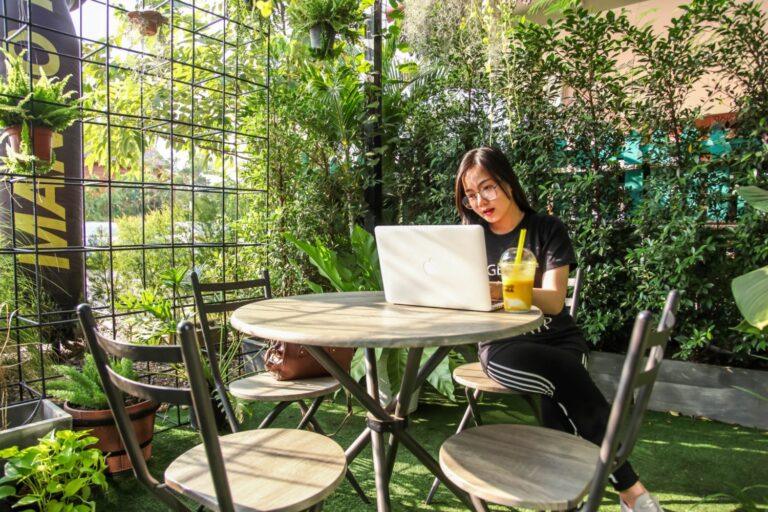 a woman sitting at a table with a laptop