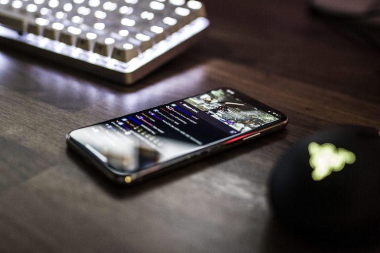 a cell phone sitting on top of a wooden table